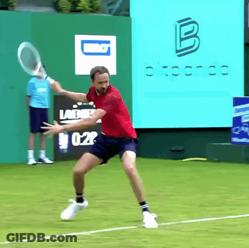 Man In Red Shirt Swinging Tennis Racket GIF