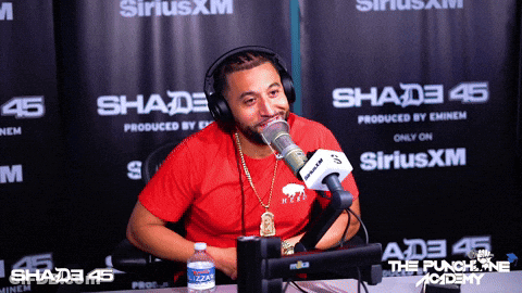 Man In Red Shirt Talking Into Microphone GIF