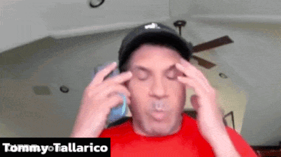 Man In Red Shirt Talking On Phone Tommy Tallarico GIF