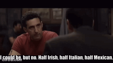 Man In Red Shirt Talking To Another In Dark Room GIF