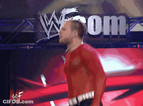 Man In Red Shirt Walking In Front Of W.com Sign GIF