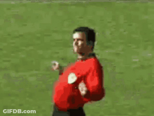 Man In Red Shirt Walking On Soccer Field GIF
