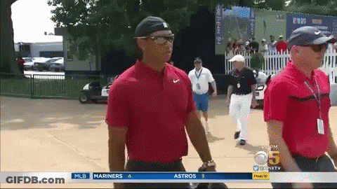 Man In Red Shirt Walking Past MLB Advertisement GIF
