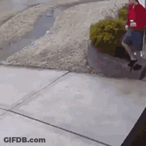Man In Red Shirt Walking With Coffee GIF