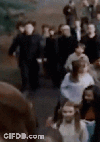Man In Red Shirt With C Facing Crowd GIF