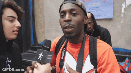 Man In Red Shirt With Camera Strap GIF