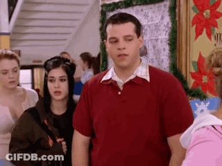 Man In Red Shirt With Group In Hallway GIF