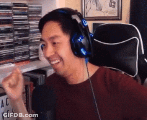 Man In Red Shirt With Headphones Sitting GIF