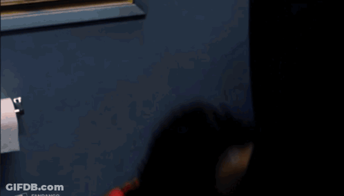 Man In Red Shirt With Necklace Looking Up GIF