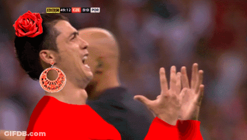 Man In Red Shirt With Rose In Hair Watching Soccer On BBC TV GIF