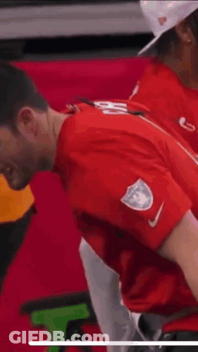 Man In Red Shirt With White Emblem GIF