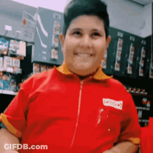 Man In Red Shirt With Yellow Collar Smiling GIF