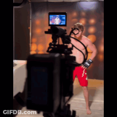 Man In Red Shorts In Front Of Camera GIF