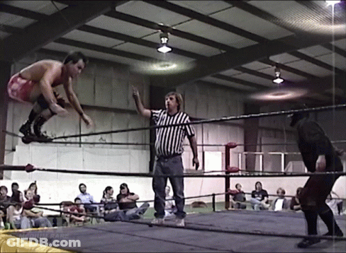 Man In Red Shorts Jumping As Referee Looks On GIF
