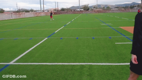 Man In Red Shorts On Soccer Field With Mountains GIF