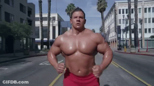 Man In Red Shorts Running Down Street GIF