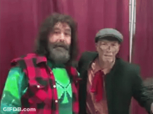 Man In Red Shorts With Orion In Wrestling Ring GIF
