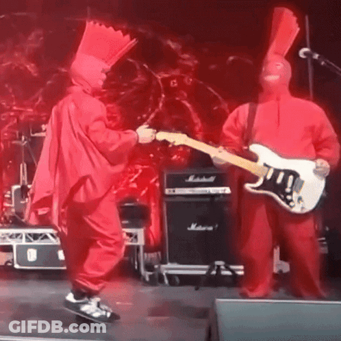 Man In Red Singing Into Microphone On Stage GIF