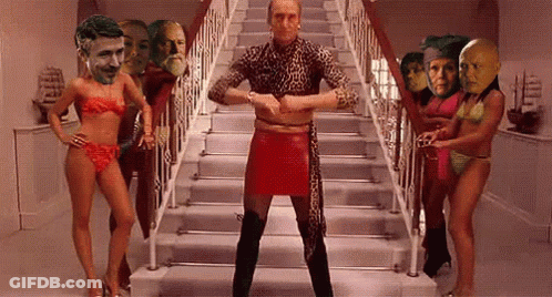 Man In Red Skirt Surrounded By Women In Bikinis GIF