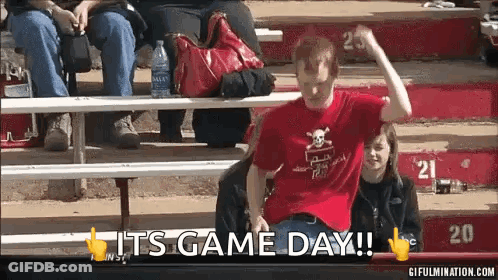 Man In Red Skull Shirt Sitting On Bleacher Saying It's Game Day GIF
