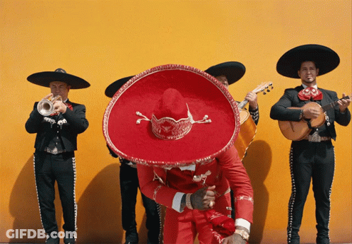Man In Red Sombrero Surrounded By Musicians GIF