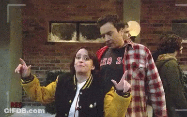 Man In Red Sox Shirt Next To Woman In Varsity Jacket GIF