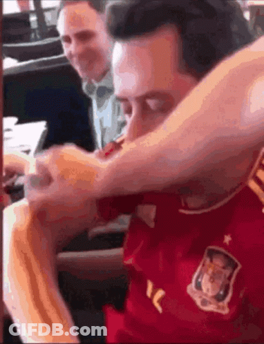 Man In Red Spain Jersey Eating Hot Dog GIF