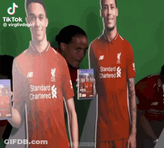 Man In Red Standard Chartered Shirt Holding Video Game GIF
