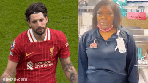 Man In Red Standard Chartered Shirt Next To Masked Woman GIF