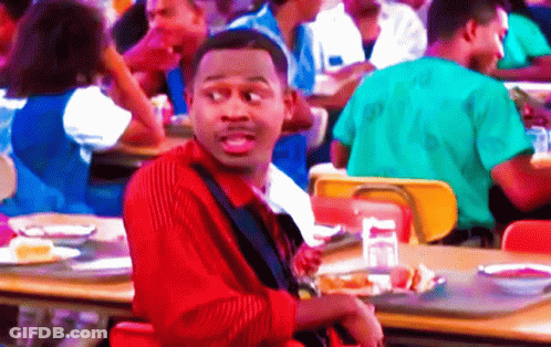 Man In Red Striped Shirt Sitting At Cafeteria Table GIF