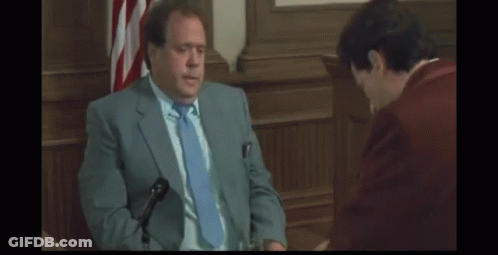 Man In Red Suit And Bow Tie Making Funny Face GIF