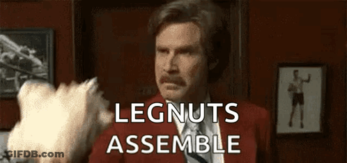 Man In Red Suit And Tie Holding Cotton Candy Saying Legnuts Assemble GIF