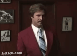 Man In Red Suit And Tie With Hello Kitty Bow GIF