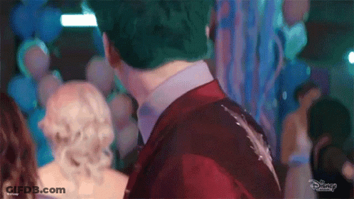 Man In Red Suit And Woman In White Dress At Party GIF