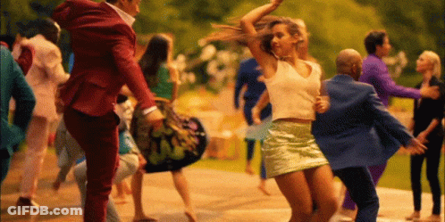 Man In Red Suit Carrying Woman In Green Skirt GIF