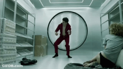 Man In Red Suit Dancing In Front Of Circle GIF
