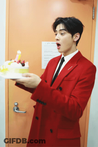 Man In Red Suit Holding Birthday Cake GIF