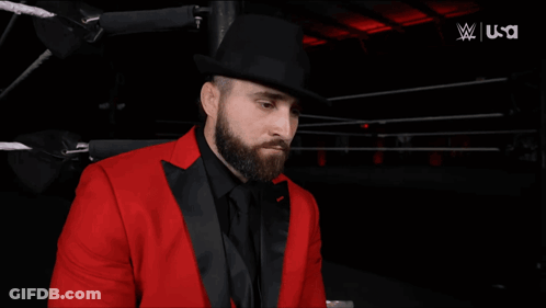 Man In Red Suit Next To Woman In White Jacket USA GIF