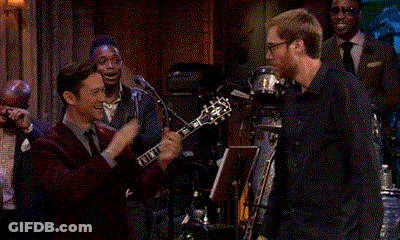 Man In Red Suit Playing Guitar For Group GIF