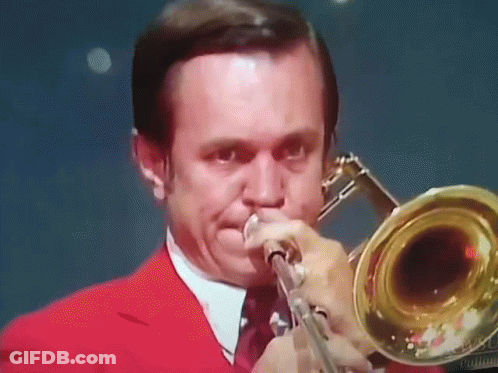 Man In Red Suit Playing Trombone GIF