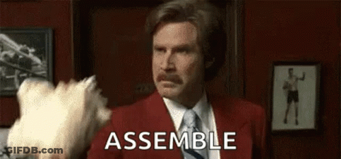 Man In Red Suit Saying Assemble With White Object GIF