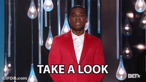 Man In Red Suit Says Take A Look On Stage GIF
