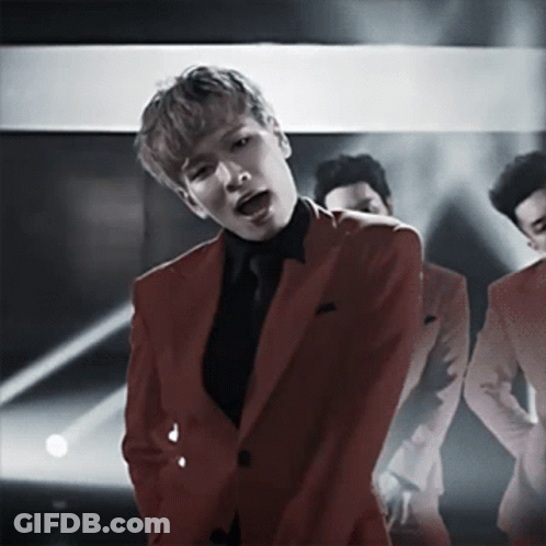 Man In Red Suit Singing Into Microphone GIF