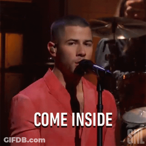 Man In Red Suit Singing Into Microphone Saying Come Inside GIF