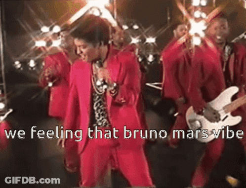 Man In Red Suit Singing Into Microphone With Guitarists GIF