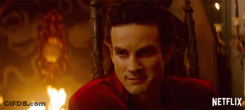 Man In Red Suit Sitting In Chair With Netflix Written Below GIF