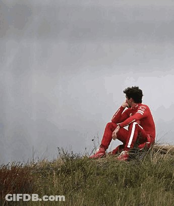 Man In Red Suit Sitting On Hill GIF