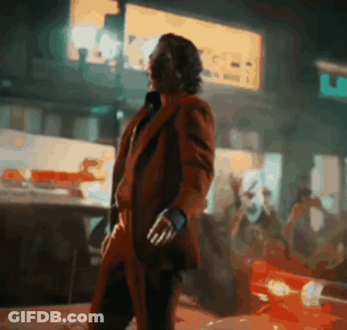 Man In Red Suit Standing In Front Of A & A Sign GIF