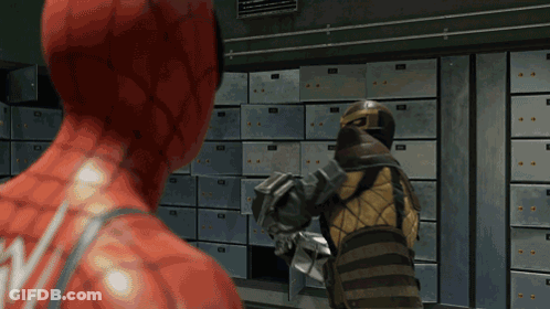 Man In Red Suit Standing Next To Man In Yellow Suit In Front Of Lockers GIF
