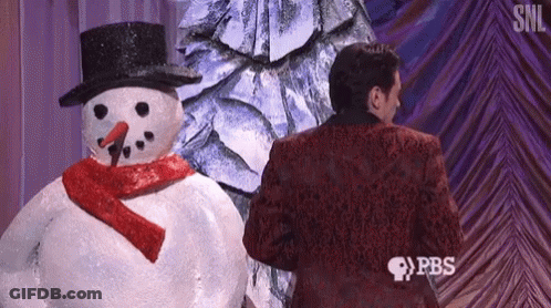 Man In Red Suit Standing Next To Snowman GIF